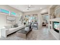 Spacious living room with a cozy fireplace and large windows at 30994 N 74Th Way, Scottsdale, AZ 85266