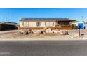 Single wide manufactured home with solar panels and a gravel driveway at 3810 W Mohawk Ln, Glendale, AZ 85308