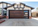 Modern garage with a sleek, dark brown door and window inserts at 4009 W Cielo Grande Rd, Glendale, AZ 85310