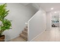 Bright entryway with staircase and tile flooring at 40561 W Hillman Dr, Maricopa, AZ 85138