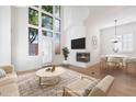 Bright living room features tall windows, a fireplace, and a modern, neutral color palette at 4430 N 22Nd St # 1, Phoenix, AZ 85016