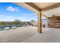 A covered patio overlooks a luxurious pool surrounded by desert landscaping and a view of the nearby mountains at 44512 N Sonoran Arroyo Ln, New River, AZ 85087