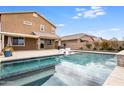 Backyard swimming pool with in-pool seating, patio, and desert landscaping at 44512 N Sonoran Arroyo Ln, New River, AZ 85087