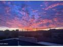 Sunset over the desert landscape with a pool in the foreground at 44512 N Sonoran Arroyo Ln, New River, AZ 85087