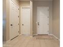 Bright and airy entryway with tile flooring and neutral colors at 4466 N 200Th Ln, Litchfield Park, AZ 85340