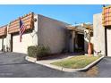 Front view of a charming home with a pergola and American flag at 5100 N Miller Rd # 20, Scottsdale, AZ 85250