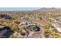 View of a home and neighborhood in a desert environment with mountains in the distance at 5655 N Camelback Canyon Dr, Phoenix, AZ 85018