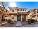 Two-story house with light brown exterior and a blue front door at 5856 E Hampton Ave, Mesa, AZ 85206