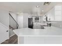 Modern kitchen with white cabinets and a breakfast bar at 6454 E University Dr # 24, Mesa, AZ 85205