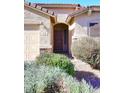 Front entrance with a brown door and surrounding shrubbery at 6808 S 36Th Dr, Phoenix, AZ 85041