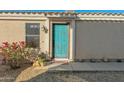 Front door entrance with teal door and desert landscaping at 6863 E Haven Ave, Florence, AZ 85132