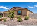 Tan house with stone accents and drought-tolerant landscaping at 7110 E Gamebird Way, San Tan Valley, AZ 85143