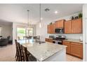 Modern kitchen featuring granite countertops and an island at 7110 E Gamebird Way, San Tan Valley, AZ 85143