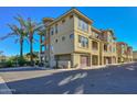 Tan 3-story building with attached garages and lush landscaping at 7275 N Scottsdale Rd # 1001, Paradise Valley, AZ 85253