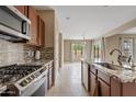 Modern kitchen featuring granite countertops and stainless steel appliances at 7846 W Adam Ave, Peoria, AZ 85382