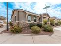 Single-story home with stone accents and landscaping at 815 S 151St Ln, Goodyear, AZ 85338