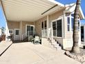 Covered patio with seating area and access to the mobile home at 840 S Aquamarine Dr, Apache Junction, AZ 85119