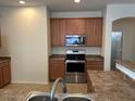 Kitchen features wood cabinets, stainless steel appliances, and plenty of counter space at 8498 W Maya Dr, Peoria, AZ 85383