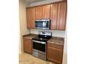 Stainless steel appliances and wood cabinets in this kitchen at 8498 W Maya Dr, Peoria, AZ 85383