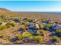 Aerial view showcasing a house with a pool and a beautiful desert landscape at 10756 E Ludlow Dr, Scottsdale, AZ 85255