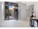 Bright entryway with open door revealing a courtyard and tiled floor at 10758 E Tamarisk Way, Scottsdale, AZ 85262