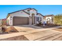 Single-story home with two-car garage and desert landscaping at 1135 E Westwood Dr, Casa Grande, AZ 85122