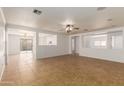 Bright living room with tile floors and ceiling fan at 11793 W Larkspur Rd, El Mirage, AZ 85335