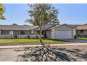 House exterior featuring a well-manicured lawn and driveway at 12719 W Shadow Hills Dr, Sun City West, AZ 85375