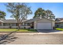 Single story home with a two car garage and front yard at 12719 W Shadow Hills Dr, Sun City West, AZ 85375