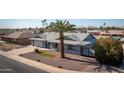 Single-story home with a landscaped yard and gated entrance at 13034 N 98Th Dr, Sun City, AZ 85351