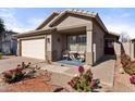 Tan two-car garage home with front porch and landscaping at 1328 E Binner Dr, Chandler, AZ 85225