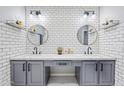 Modern bathroom with double vanity, gray cabinets, and white subway tile at 1436 E Rosemonte Dr, Phoenix, AZ 85024