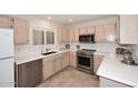 Well-equipped kitchen featuring stainless steel appliances and light wood cabinets at 15050 N Thompson Peak Pkwy # 1010, Scottsdale, AZ 85260