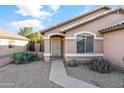 Front entry with walkway, landscaping, and exterior light at 15913 W Elm St, Surprise, AZ 85374