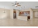 Open kitchen with an island, stainless steel appliances, and granite countertops at 16955 W Holly St, Goodyear, AZ 85395