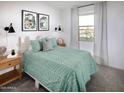 Guest bedroom with a green duvet and wood nightstand at 20775 N Roadrunner Ln, Maricopa, AZ 85138