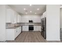 Modern white kitchen with stainless steel appliances at 2125 E Voltaire Ave, Phoenix, AZ 85022