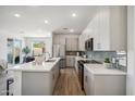 Modern kitchen with stainless steel appliances and white cabinetry at 2126 E Voltaire Ave, Phoenix, AZ 85022