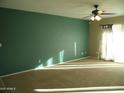 Spacious living room with neutral carpeting and teal accent wall at 2208 W Lindner Ave # 17, Mesa, AZ 85202