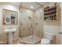 Bathroom with glass shower, pedestal sink, and storage at 2211 E Camelback Rd # 201, Phoenix, AZ 85016