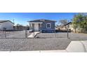 Front view of a house with gray stucco and a gravel yard at 232 S San Carlos St, Florence, AZ 85132