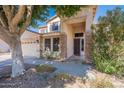 Inviting front entrance with stone accents, covered porch, and well-maintained landscaping at 2418 E Glass Ln, Phoenix, AZ 85042