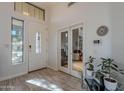 Bright foyer features a glass-paneled front door, decorative tile flooring, and an office through glass French doors at 2418 E Glass Ln, Phoenix, AZ 85042