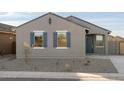 Two-toned home exterior with gray siding, blue shutters, and a dark blue front door at 2669 E Santa Ynez Dr, Casa Grande, AZ 85194