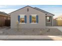 Modern curb appeal with gray exterior, blue shutters, and rock landscaping at 2669 E Santa Ynez Dr, Casa Grande, AZ 85194