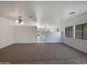 Spacious living room with neutral carpeting and tile flooring at 3057 E Superior Rd, San Tan Valley, AZ 85143