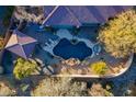 Overhead view of a kidney shaped pool with a pergola and lounge chairs at 32029 N 19Th Ln, Phoenix, AZ 85085