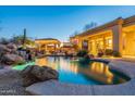 Inviting pool and spa with a waterfall feature, covered patio, and outdoor lighting at 32029 N 19Th Ln, Phoenix, AZ 85085