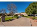 House with a long driveway and lush lawn at 3464 N Ashbrook St, Mesa, AZ 85213