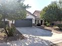 House exterior featuring a two-car garage and well-maintained landscaping at 35801 N Zachary Rd, San Tan Valley, AZ 85144